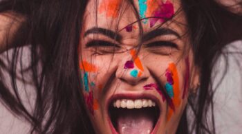 a woman with face paint screaming