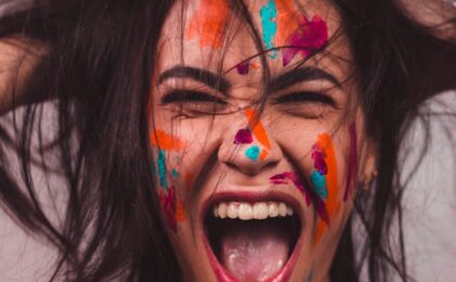 a woman with face paint screaming