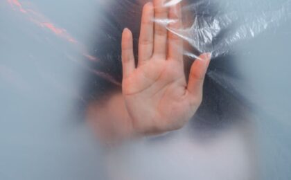 hand pushing on plastic foil