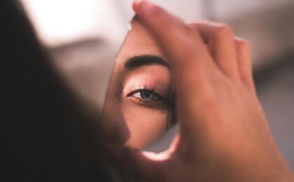 reflection of woman s eye on broken mirror