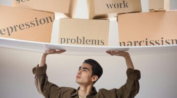 man standing with arms raised and holding boxes with problems